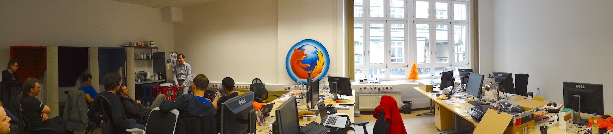 Panorama picture in the Mozilla Berlin Office. Attendees sit on chairs discussing ideas.